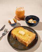 Roti Bakar is a typical grilled Indonesian sandwich, consisting of two slices of bread and filling, served with Teh Tarik and boiled egg. photo