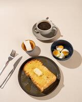 Roti Bakar is a typical grilled Indonesian sandwich, consisting of two slices of bread served with eggs and coffee photo