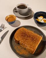 Roti Bakar is a typical grilled Indonesian sandwich, consisting of two slices of bread served with eggs and coffee photo
