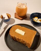 Roti Bakar is a typical grilled Indonesian sandwich, consisting of two slices of bread and filling, served with Teh Tarik and boiled egg. photo
