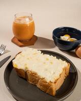 Roti Bakar is a typical grilled Indonesian sandwich, consisting of two slices of bread and filling, served with Teh Tarik and boiled egg. photo