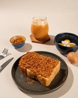 Roti Bakar is a typical grilled Indonesian sandwich, consisting of two slices of bread and filling, served with Teh Tarik and boiled egg. photo
