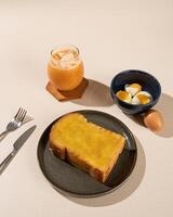 Roti Bakar is a typical grilled Indonesian sandwich, consisting of two slices of bread and filling, served with Teh Tarik and boiled egg. photo
