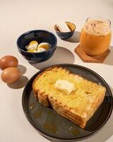 Roti Bakar is a typical grilled Indonesian sandwich, consisting of two slices of bread and filling, served with Teh Tarik and boiled egg. photo