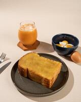 Roti Bakar is a typical grilled Indonesian sandwich, consisting of two slices of bread and filling, served with Teh Tarik and boiled egg. photo