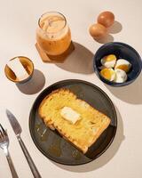 Roti Bakar is a typical grilled Indonesian sandwich, consisting of two slices of bread and filling, served with Teh Tarik and boiled egg. photo