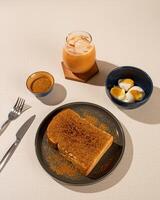 Roti Bakar is a typical grilled Indonesian sandwich, consisting of two slices of bread and filling, served with Teh Tarik and boiled egg. photo