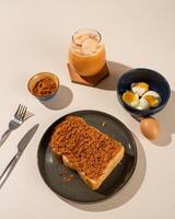 Roti Bakar is a typical grilled Indonesian sandwich, consisting of two slices of bread and filling, served with Teh Tarik and boiled egg. photo