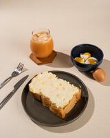 Roti Bakar is a typical grilled Indonesian sandwich, consisting of two slices of bread and filling, served with Teh Tarik and boiled egg. photo
