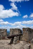 Marvao, Portugal. May 19, 2024. Battlements of Marvao Castle with old cannons pointing toward the scenic landscape, capturing history and panoramic views in a display of medieval defense architecture. photo