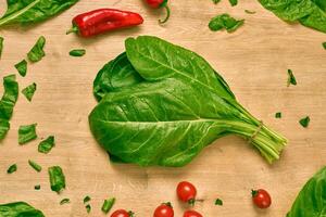 fresh organic spinach on a cutting board photo