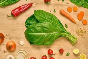 fresh organic spinach on a cutting board photo