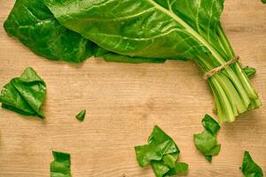 fresh organic spinach on a cutting board photo