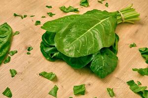 fresh organic spinach on a cutting board photo