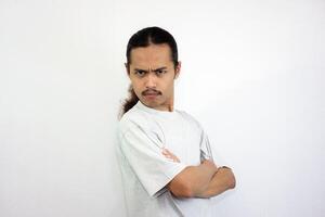 Annoyed and angry man with folded hands. looking at the camera angrily. isolated on white background photo