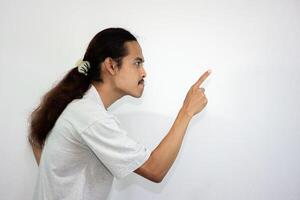 Upset and angry man with hand pointing to another direction, isolated on white background. photo