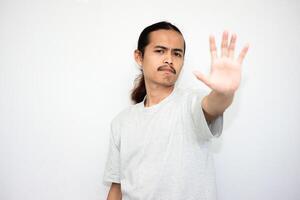 Annoyed and angry man raises hand and says no, looking at camera angrily. isolated on white background photo