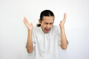 Upset and angry man raising both hands while shouting. looking at the camera angrily. isolated on white background photo