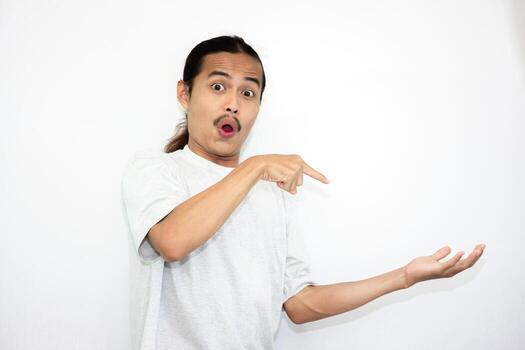 The shocked Asian man stood up while serving something beside him. Isolated on white with copy space photo