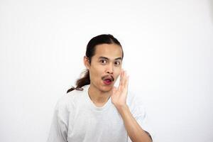 Asian man who is surprised and makes an expression of wanting to gossip. isolated in white background photo