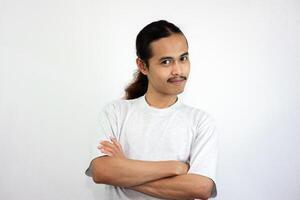 Asian man wearing gray tshirt and long hair smiling at the camera. isolated in white background photo