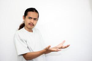 Asian man in gray tshirt pointing to the side. isolated on white studio background. Asian man with long hair photo