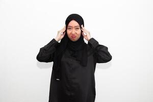 Sad woman in hijab holding hands on head, suffering from headache, suffering from migraine, feeling dizzy, standing on white background. photo