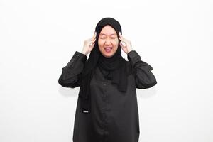 Sad woman in hijab holding hands on head, suffering from headache, suffering from migraine, feeling dizzy, standing on white background. photo