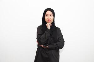 Photo of a bored woman wearing a hijab. wearing a shirt looks empty space with isolated white color background