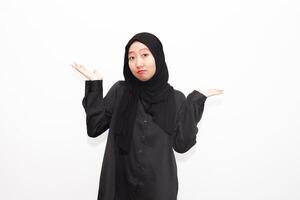 Photo of a bored woman wearing a hijab. wearing a shirt looks empty space with isolated white color background