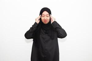 Sad woman in hijab holding hands on head, suffering from headache, suffering from migraine, feeling dizzy, standing on white background. photo