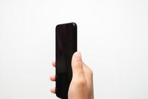 Man's hand holding a smart phone screen view from above. isolated in white background photo