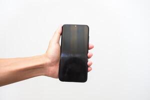 Man's hand holding a smart phone screen view from above. isolated in white background photo