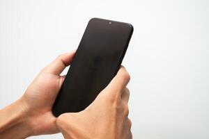 Man's hand holding a smart phone screen view from above. isolated in white background photo