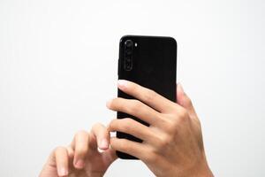 Man's hand holding a smart phone screen view from above. isolated in white background photo