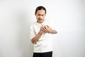 A young man clutched his chest. Severe pain, shortness of breath, panic attacks, heart attacks, strokes. isolated in white background photo