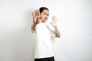 Young man wearing a white t-shirt. make movements not with your hands. crossed arms. There isn't any. sign isolated on white background photo