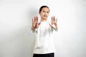 Young man wearing a white t-shirt. make movements not with your hands. crossed arms. There isn't any. sign isolated on white background photo