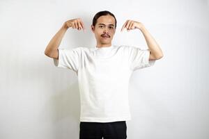 Asian man in white t-shirt pointing down. isolated on white studio background. photo