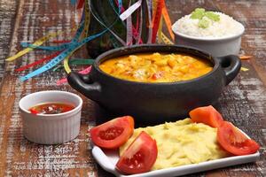 Shrimp moqueca with palm oil and white rice photo