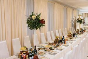 Glasses on the festive table setting. Wedding table decor concept. Table setting in classic style, setout. fine art. photo