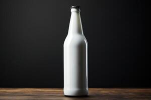 A bottle of beer with a white label on a black background. photo