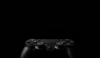 Modern black gamepad on a dark background. Game concept with copy space for text or design. photo