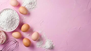 pink background top view background for baking, flour, eggs, whisk photo