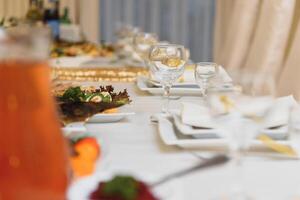 Glasses on the festive table setting. Wedding table decor concept. Table setting in classic style, setout. fine art. photo