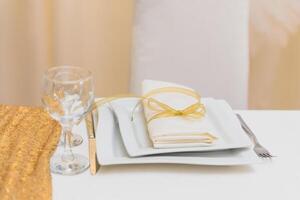 Glasses on the festive table setting. Wedding table decor concept. Table setting in classic style, setout. fine art. photo