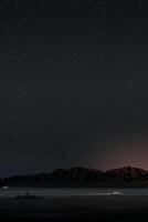 Landscape at night with car on local road through the field and mountain ranges have a lot of star in the sky vertical background. vector