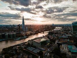 Expansive London Cityscape with Tower Bridge and the Shard Under Moody Skies photo