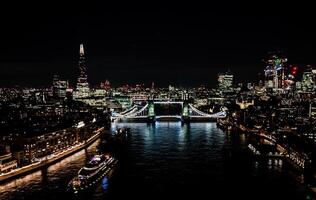 London's Tower Bridge Glows Brightly Against the Twilight Sky, Offering a Stunning Sight from High Above photo