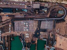 Panoramic view of busie cargo port with hundreds of ships loading export and import goods and thousands of containers in. photo